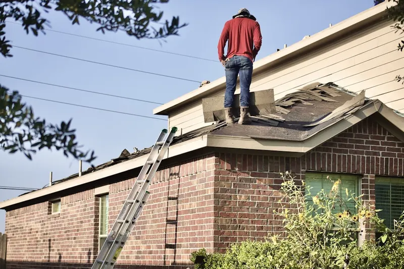 Professional roofer working on a residential roof in Downtown Melrose